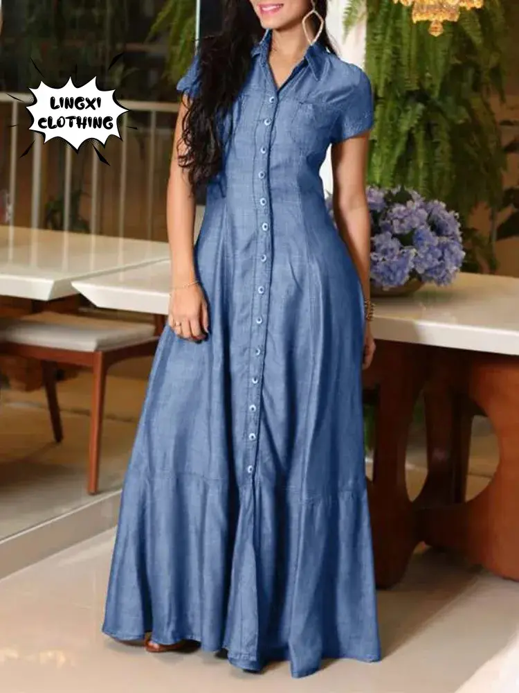 A woman in a long blue dress standing on top of a table.