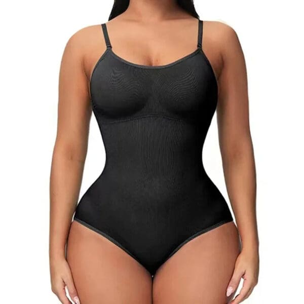 A woman wearing a black body suit with no bra.