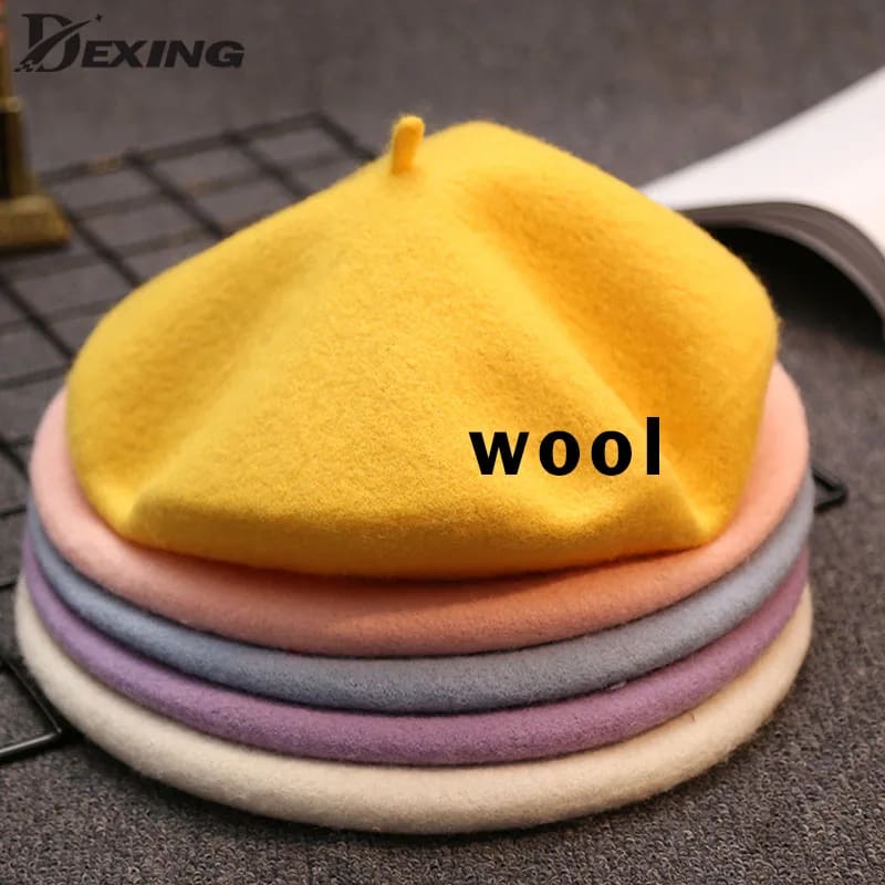 A pile of different colored wool hats on top of each other.