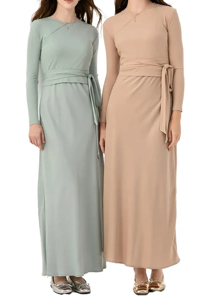 Two women in long dresses standing next to each other.