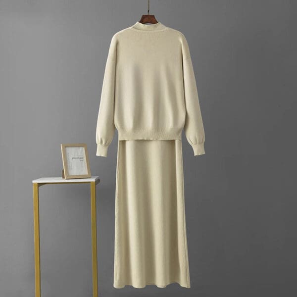 A white sweater and skirt set on a table