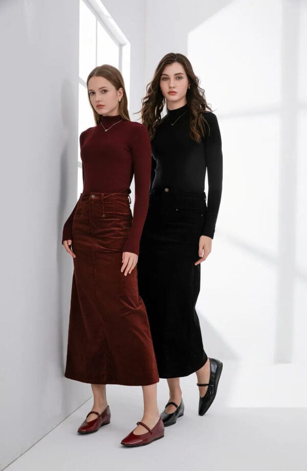 Two women in black and red outfits standing next to each other.