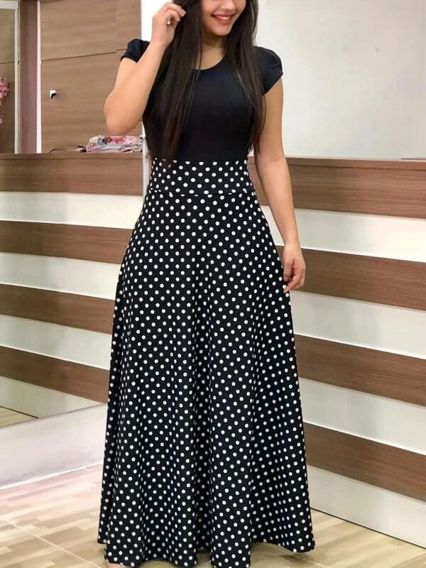 A woman in black and white polka dot dress.