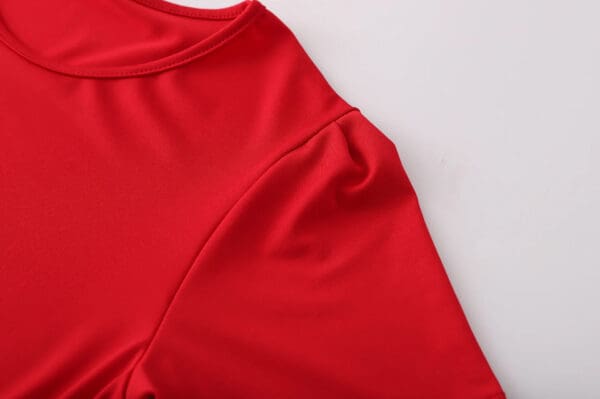 A close up of the shoulder area of a red shirt.