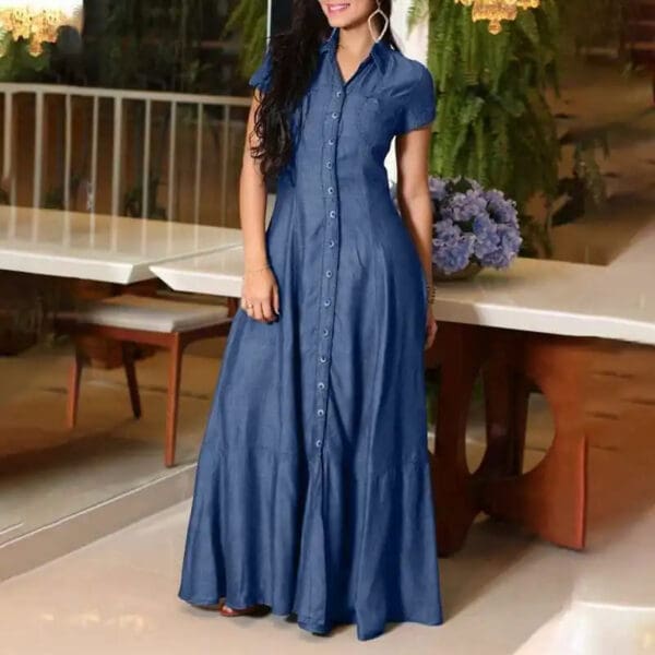 A woman in blue dress standing on the floor.