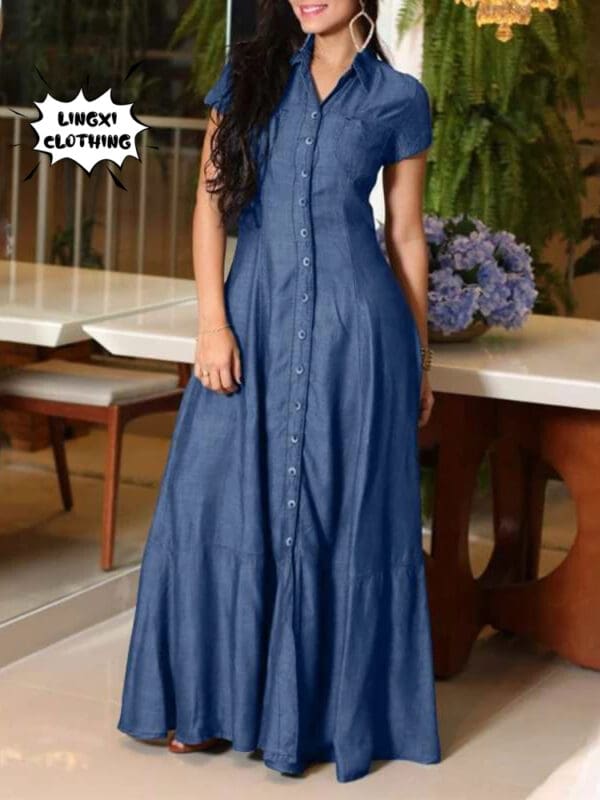 A woman in blue dress standing next to a table.