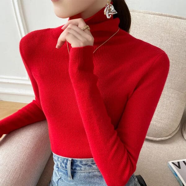 A woman wearing jeans and red shirt