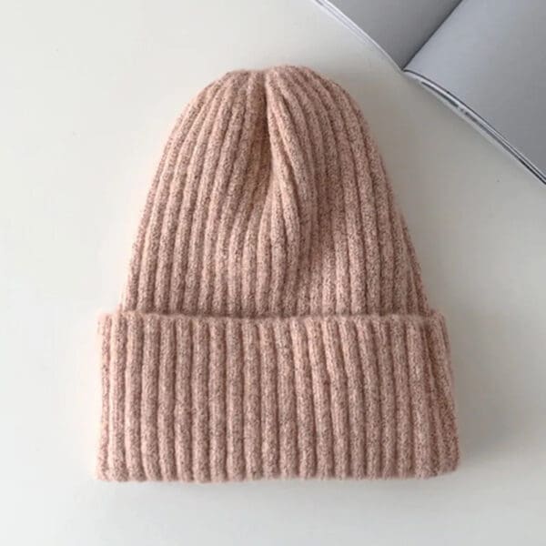 A pink beanie is sitting on top of the table.