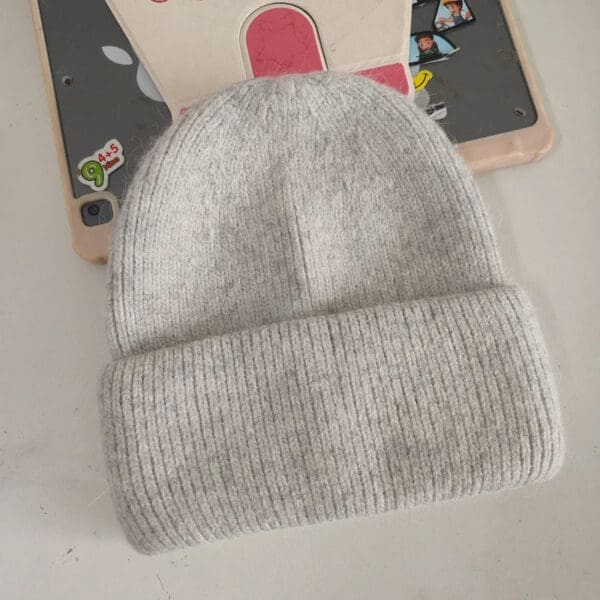 A gray beanie is on top of the table.