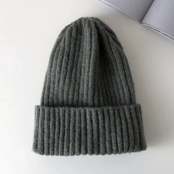 A gray beanie is sitting on the floor.