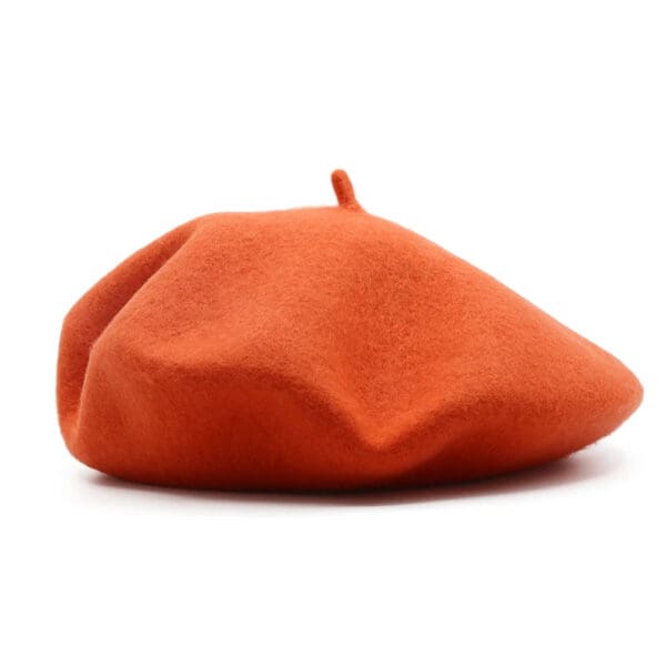 A red hat is sitting on top of the floor.