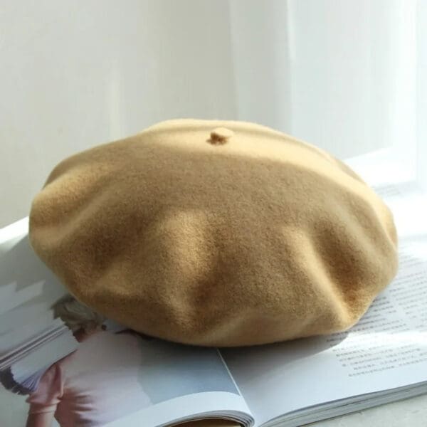 A beret is sitting on top of a magazine.