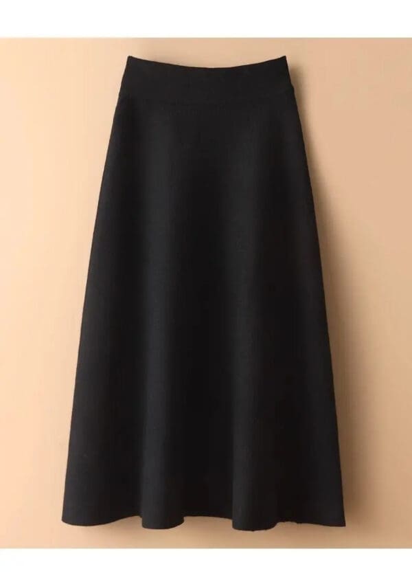 A black dress hanging on the wall