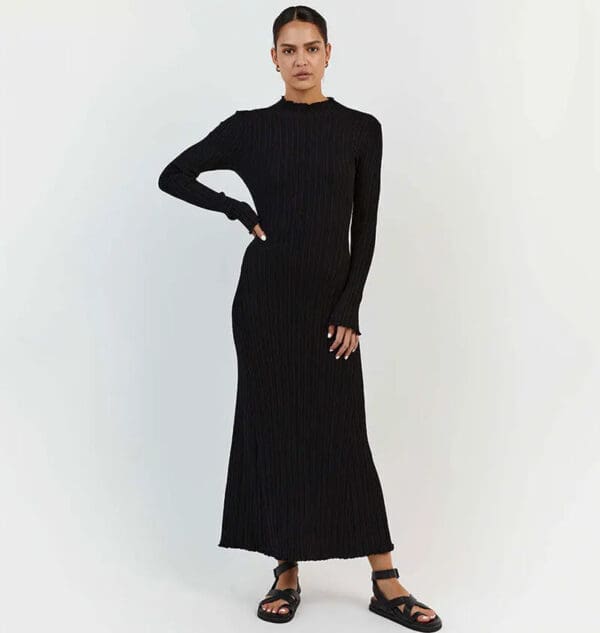 A woman in black dress standing on white background.