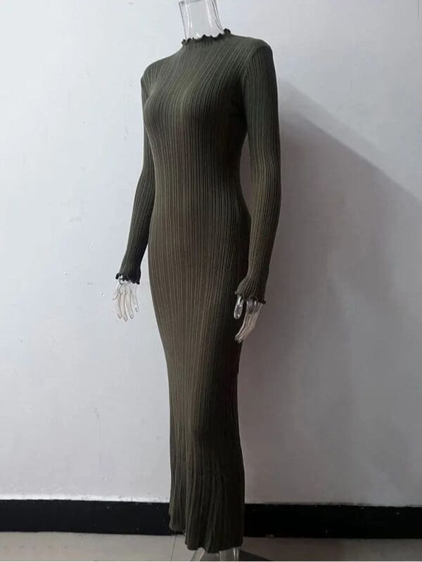 A mannequin wearing a long dress in the shape of a woman 's body.