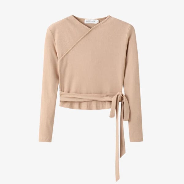 A beige sweater with a belt around the waist.