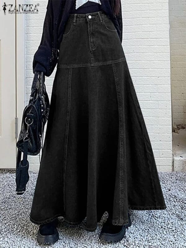 A woman in black dress holding purse and standing on sidewalk.